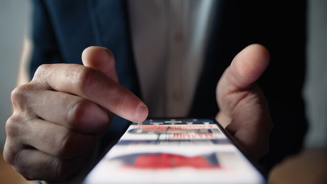 Fingers moving mobile display checking social media feed online indoors closeup