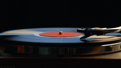 Hand turning off vinyl turntable in night room closeup. Unrecognizable man 