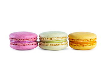 Row of colorful French macarons isolated on white background.