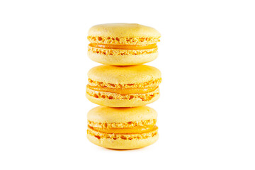 Three yellow macarons isolated on a white background.