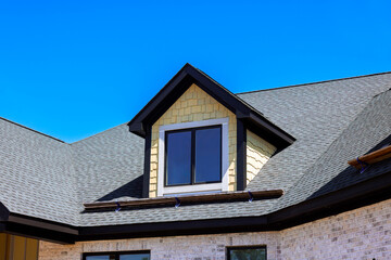 Modern house features stylish triangular roof large window set during works daytime.