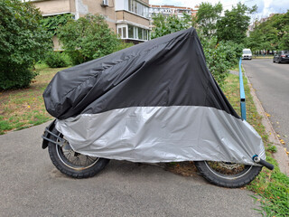 Black and gray cover on motorcycle parked in the yard of house © Harmony Video Pro