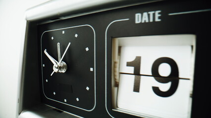 Classic flip clock standing at white surface closeup. Traditional timepiece