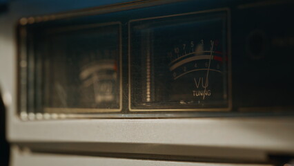 UV needle moving inside audio scale on vintage tuner closeup. Macro volume meter