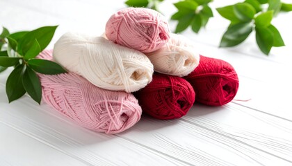 Colorful yarn balls on a white wooden surface