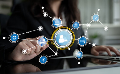 A business professional interacts with digital networks in a modern office, utilizing technology to enhance connectivity and streamline data sharing through innovative graphics. Crux