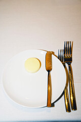 a plate with a butter knife and butter on it