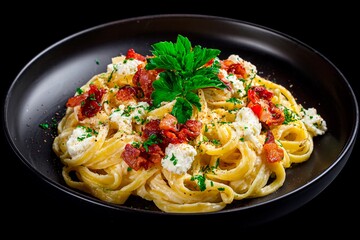 Bowl of creamy pasta features bacon, fresh tomatoes, and cheese, topped with parsley. Ideal for a cozy dinner or special occasion, showcasing rich flavors and appealing colors