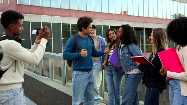 Young student vlogger interviewing friends on university campus for social media