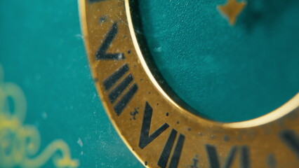 Closeup vintage clock measuring time in calm studio. Dial with roman numerals