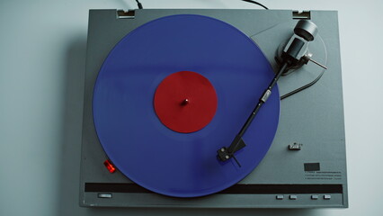Hand taking stylus vinyl record rotating at analog vintage player closeup. 