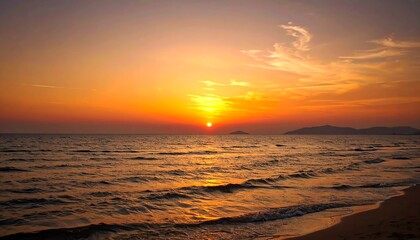 Tranquil sunset over a calm sea with soft waves washing the sandy shore