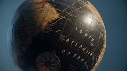 Beautiful globe spinning indoors closeup. Stylish vintage planet model rotating