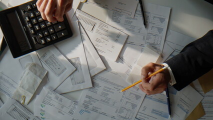 Top view businessman counting budget working with financial statements papers