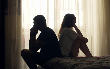 A couple sits together in silence, emotionally distant and disconnected. Despite physical closeness, tension and isolation dominate. A visual concept of relationship crisis and mental health.