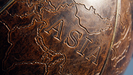 Closeup Asia continent illustrated on old leather globe surface. Mainland part 