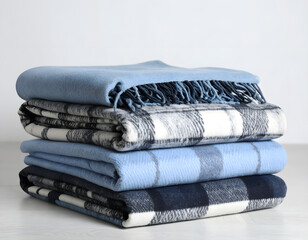 Soft and Cozy Blankets Stacked on a Minimalistic White Surface