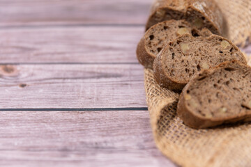Slices of rye bread, slices of wholemeal bread on a wooden background