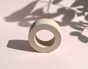 Minimalist White Tape Roll with Soft Shadow on Pink Background