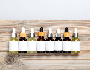 Assorted Essential Oils in Dropper Bottles on Wooden Surface