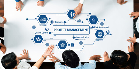 A team collaborates around a visual project management strategy, showcasing key elements like...