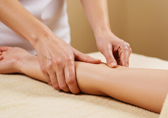 Naklejka premium Masseuse Performing Arm Massage During Spa Treatment