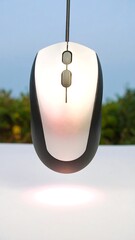 Computer mouse suspended in the air