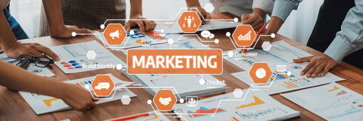 Diverse team members collaborating on marketing strategies with digital charts and graphs, focusing on consumer insights and effective product development techniques. Amity