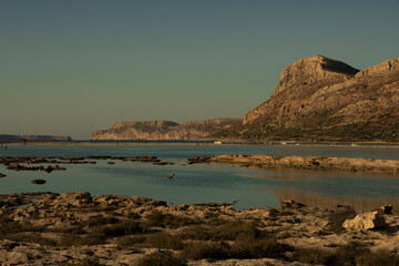 Sunset bathes Balos in golden light—where sea, cliffs, and silence merge into a timeless Mediterranean dream