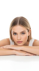 Obraz premium Portrait of a Young Woman with Blonde Hair and Blue Eyes, Posing with Her Arms Crossed on a White Surface, Looking Directly at the Camera
