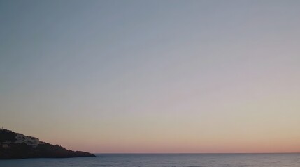 Fototapeta premium Serene Coastal Sunset Landscape, Calm Sea, Pink Sky, Hillside Homes