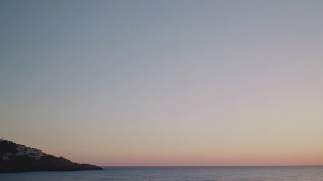 Serene Coastal Sunset Landscape, Calm Sea, Pink Sky, Hillside Homes