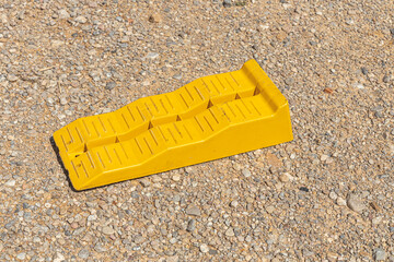 Yellow leveling block on the brown soil