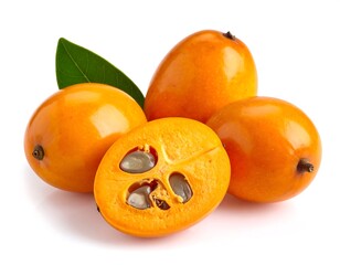 Close-up of three ripe, orange fruits, one sliced open
