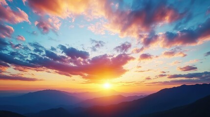 Fototapeta premium Vibrant sunset paints the sky with orange pink and blue hues over silhouetted mountain ranges