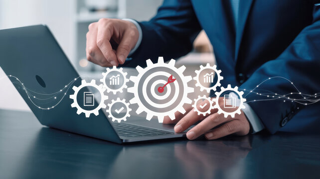 Businessman using laptop with gear icons representing business process, workflow, automation, and data analysis for achieving goals - Powered by Adobe