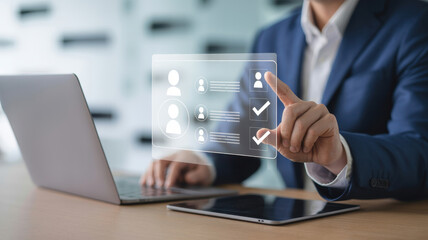 A businessman using a laptop to search for an employee or job seeker profile to fill a vacancy, hr and recruitment concept