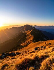 Golden hour sunset illuminates a ridgeline of rolling, golden-hued mountains, with sun rays piercing through the atmospheric haze, casting long shadows across the grassy foreground