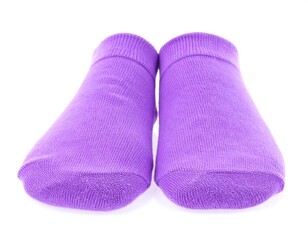 Pair of purple ankle socks on white background