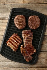 Delicious grilled beef meat on wooden table, top view