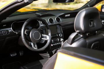 Interior of modern cabriolet parked outdoors, closeup