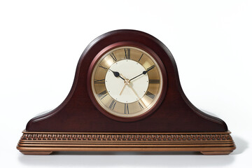 An elegant vintage wooden mantel clock with a golden face and Roman numerals, isolated on a white background.