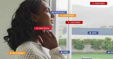 Mid adult woman tucking hair by door with send message prompt fading media icons bursting clearing