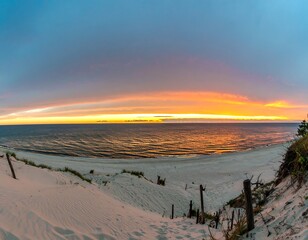 Panoramic sunset over a beach with dunes