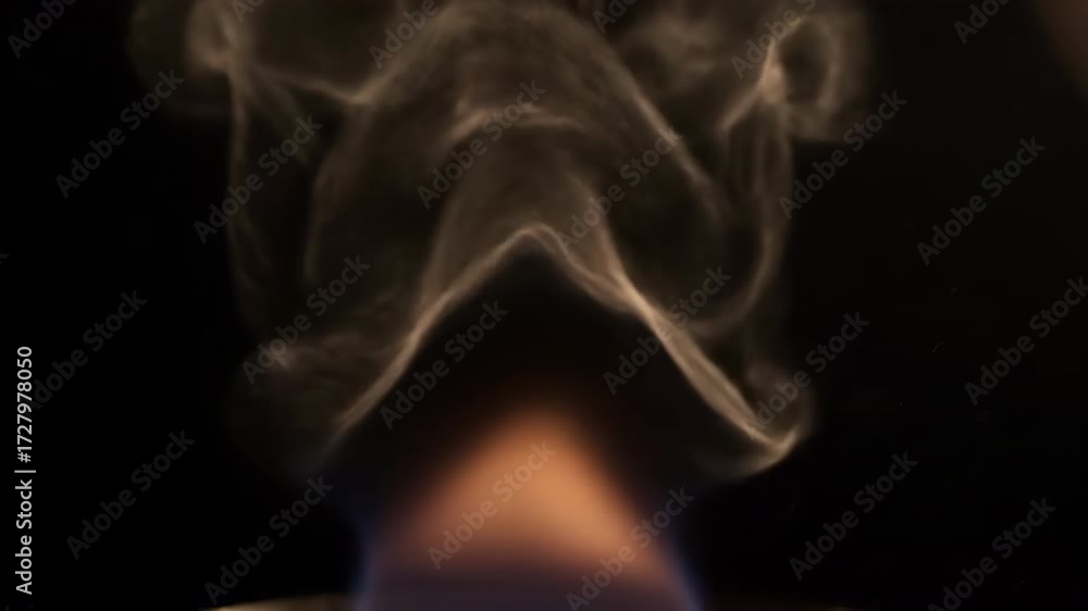 Sticker abstract slow motion of rising heat distortion above a subtle flame against a dark background macro,