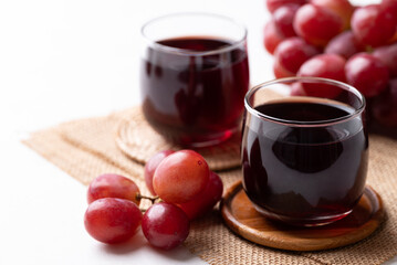 Red grape juice in glass and fresh grapes fruit, Healthy drink