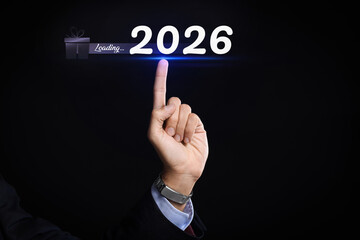 Young businessman using virtual screen on dark background