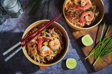 Pad Thai stir-fried with shrimp, eggs, peanuts and lime, served in paper.