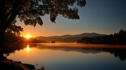 Obraz premium Serene Sunrise over Tranquil Lake with Majestic Mountains in the Background and Lush Greenery Framing the Scene in Soft Golden Light