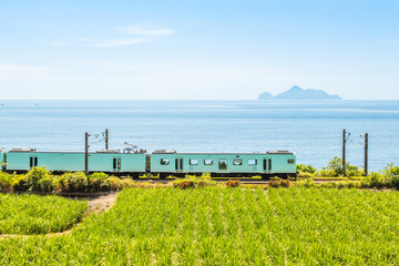 Sea breeze sightseeing train passing the field in Yilan, Taiwan